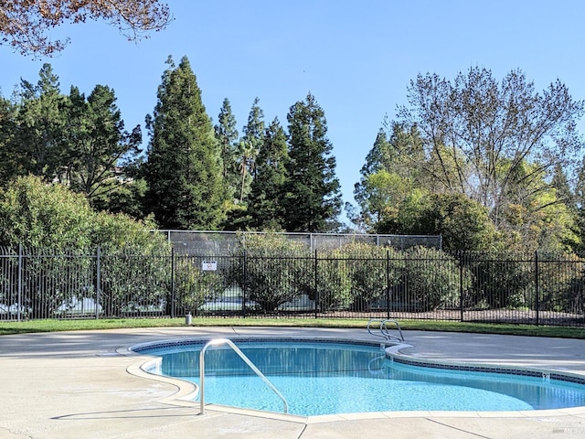 view of swimming pool with fence and a fenced in pool