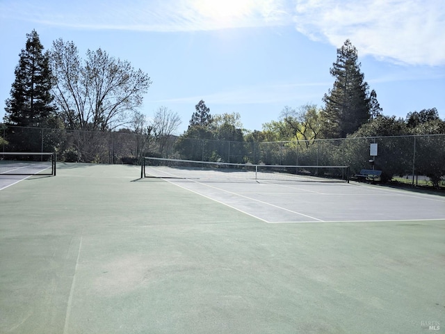 view of sport court featuring fence