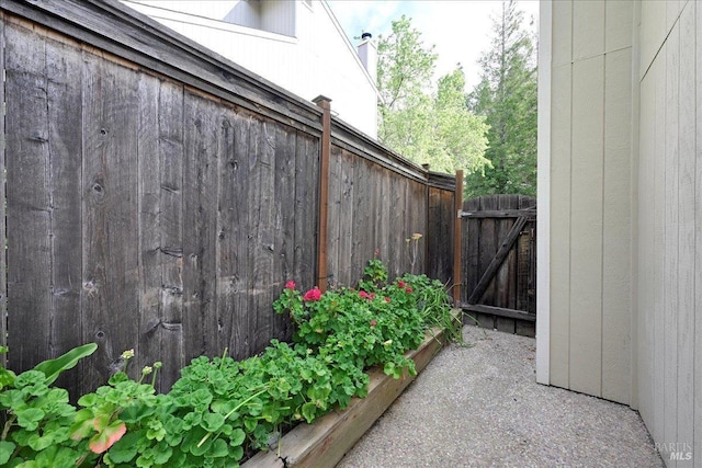 view of patio featuring fence and a gate