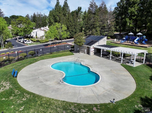 pool featuring a pergola, a patio area, playground community, a yard, and fence