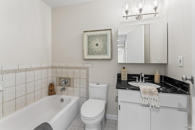 bathroom featuring toilet, vanity, a bath, baseboards, and tile patterned floors