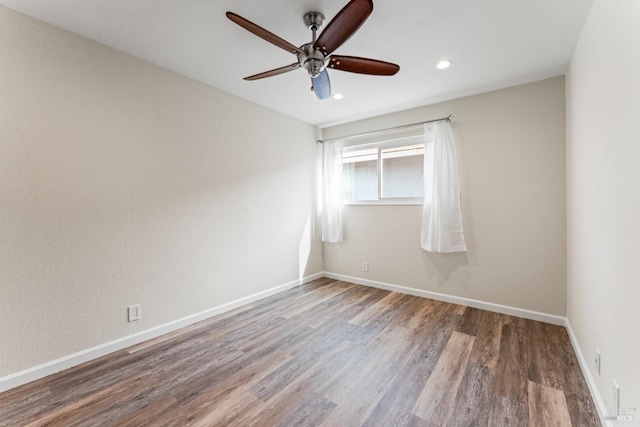 spare room featuring a ceiling fan, recessed lighting, baseboards, and wood finished floors