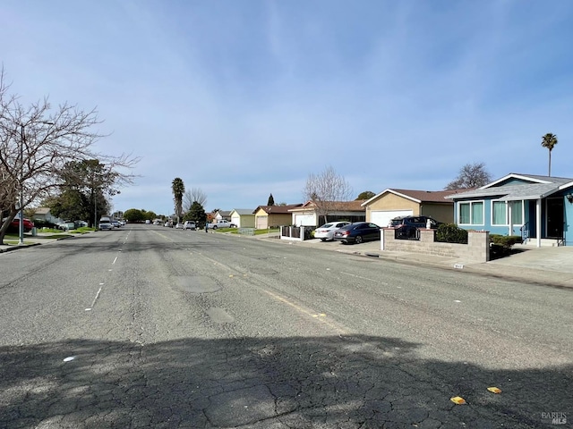 view of street with curbs and a residential view