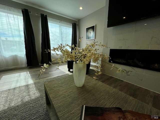 interior space featuring a tiled fireplace and wood finished floors