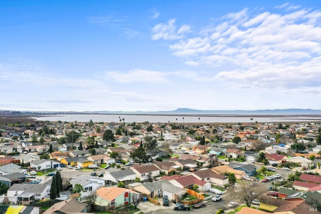 drone / aerial view with a residential view and a water and mountain view