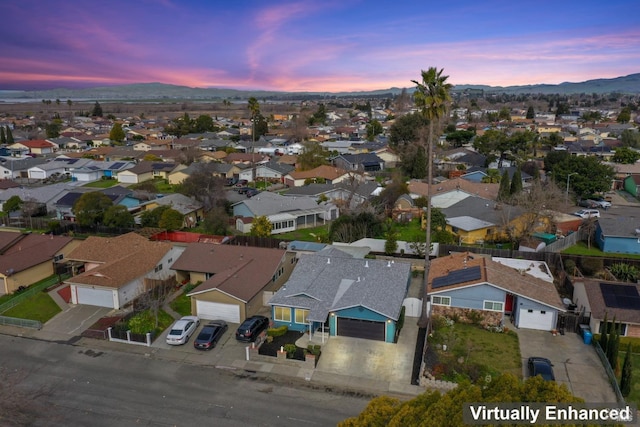 aerial view at dusk with a residential view and a mountain view