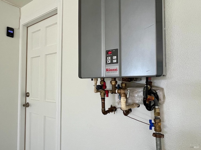 utility room featuring tankless water heater