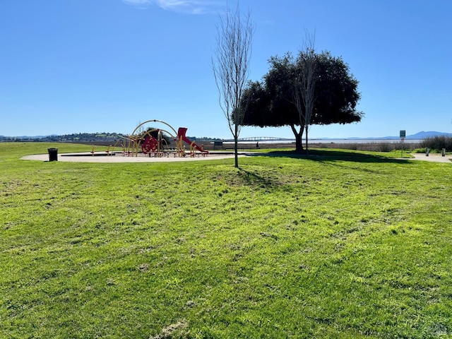 surrounding community featuring playground community and a lawn