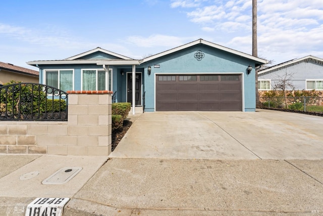 single story home with a garage, driveway, fence, and stucco siding