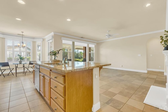 kitchen with crown molding, baseboards, light stone counters, a sink, and ceiling fan with notable chandelier