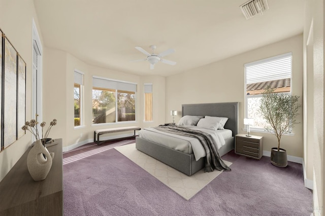 carpeted bedroom featuring visible vents, a ceiling fan, baseboards, and multiple windows