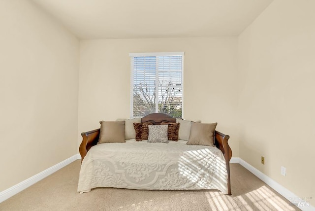 carpeted bedroom featuring baseboards
