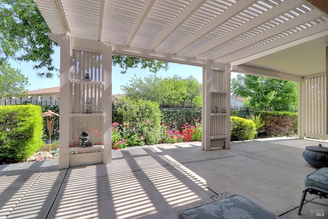 view of patio with a pergola and fence