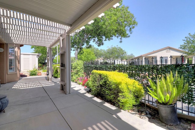 view of patio with fence and a pergola