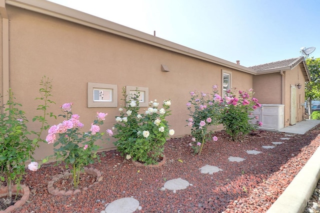 view of side of property with stucco siding