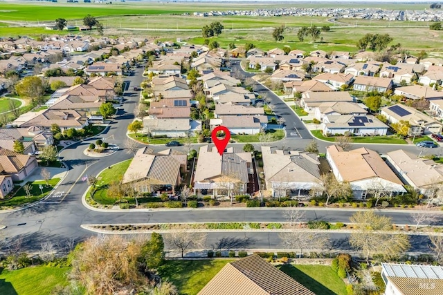 drone / aerial view featuring golf course view and a residential view