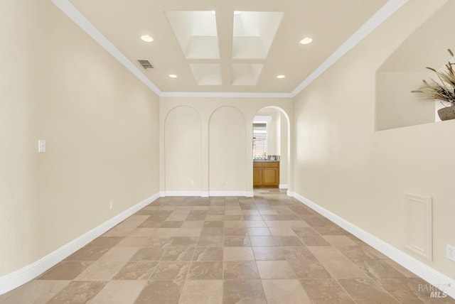 spare room with visible vents, crown molding, arched walkways, baseboards, and recessed lighting