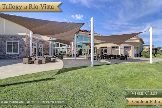 view of home's community with a lawn, a patio, and an outdoor hangout area