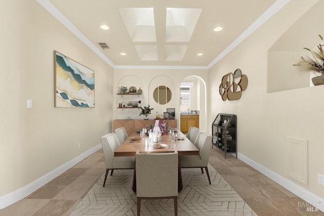 dining room with crown molding, visible vents, baseboards, recessed lighting, and arched walkways