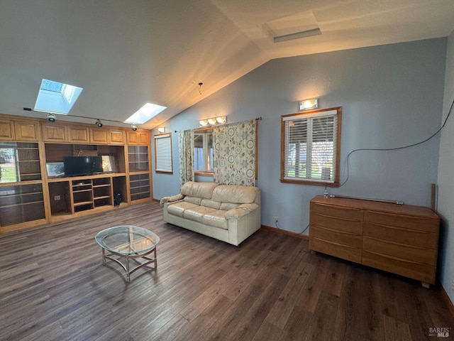 living room with dark wood-style floors, vaulted ceiling with skylight, and baseboards