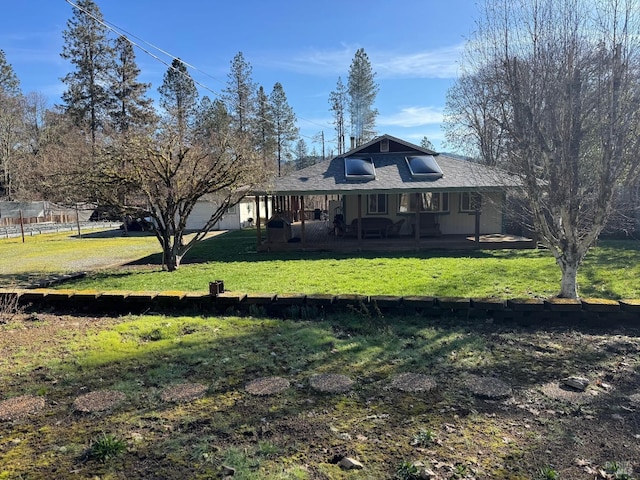 exterior space featuring covered porch, a yard, and a garage