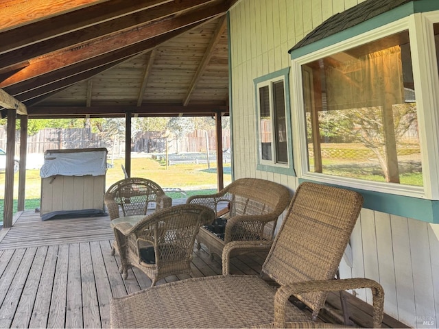 wooden terrace featuring radiator, a gazebo, and a yard