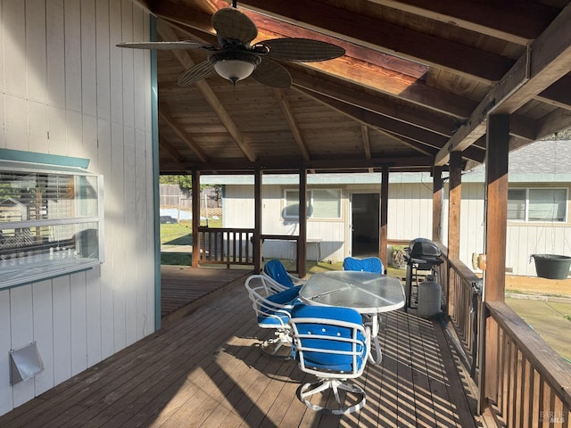 wooden deck with a gazebo, a grill, a ceiling fan, and outdoor dining space