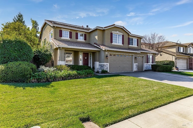 traditional-style house with an attached garage, a tile roof, concrete driveway, stucco siding, and a front lawn