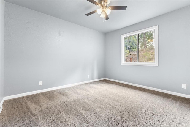 spare room featuring carpet floors, baseboards, and a ceiling fan