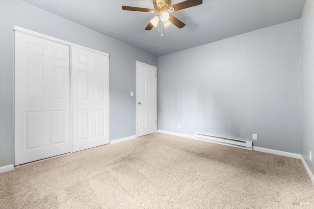 unfurnished bedroom featuring a closet, baseboards, baseboard heating, and carpet flooring