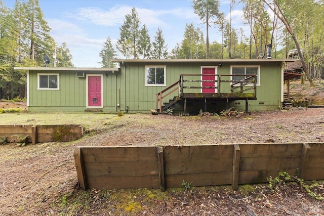 view of front of property featuring crawl space, stairway, and a wooden deck