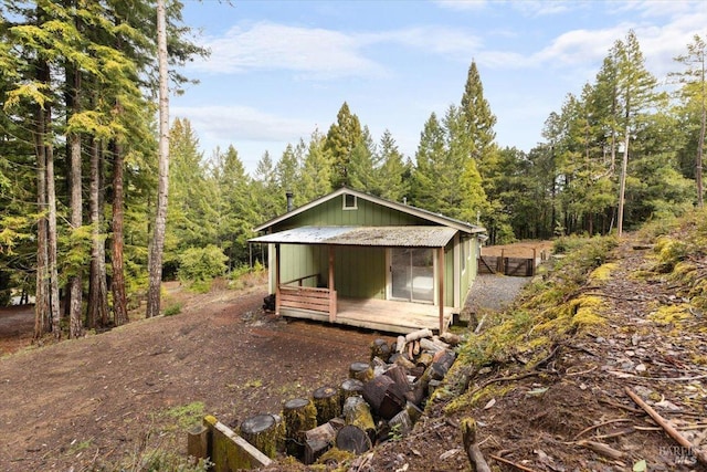 view of outbuilding with a forest view