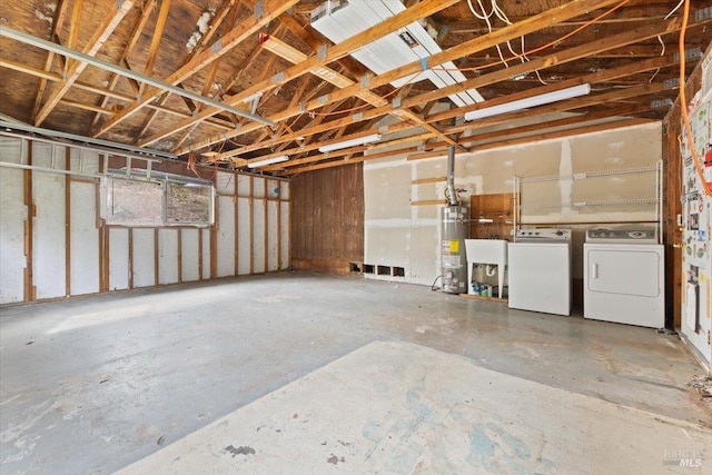 garage featuring gas water heater and independent washer and dryer