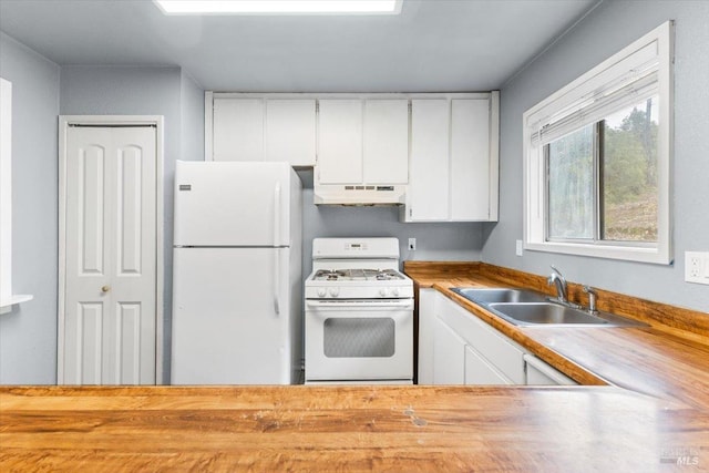 kitchen featuring under cabinet range hood, white appliances, butcher block countertops, a sink, and white cabinets