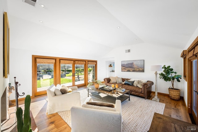 living room with light wood-style floors, recessed lighting, visible vents, and french doors