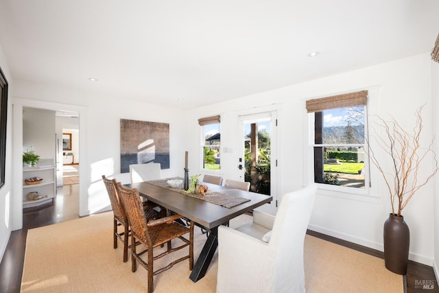 dining room featuring light wood-style flooring, baseboards, and recessed lighting