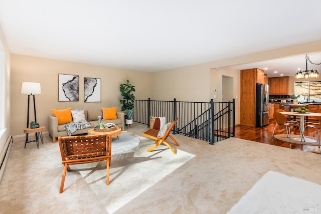 living room featuring a chandelier and dark colored carpet