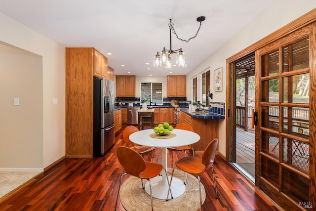 dining room with dark wood-style floors, recessed lighting, and baseboards