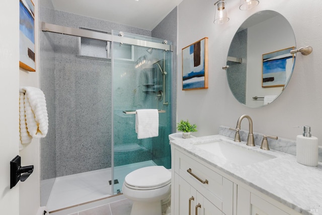 bathroom with tile patterned flooring, vanity, toilet, and a shower stall