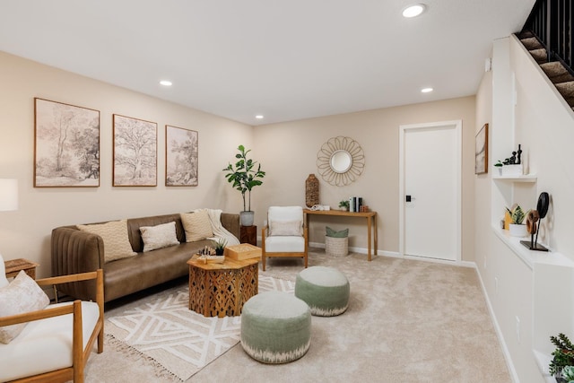 living area with recessed lighting, light colored carpet, baseboards, and stairs