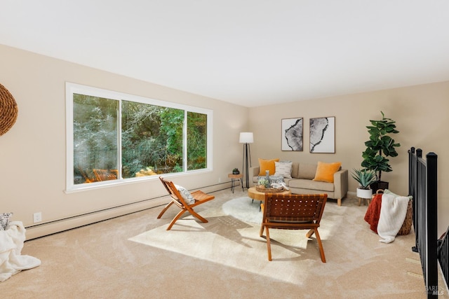 living area with a baseboard heating unit and light colored carpet