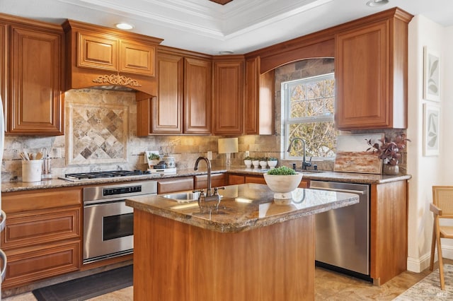 kitchen with brown cabinets, a kitchen island with sink, stainless steel appliances, and a sink