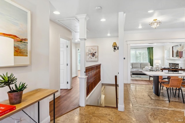 corridor with crown molding, recessed lighting, decorative columns, and baseboards