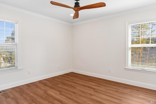 unfurnished room featuring baseboards, visible vents, and a wealth of natural light