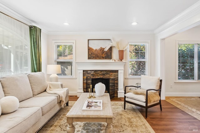 living area with a wealth of natural light, crown molding, and wood finished floors