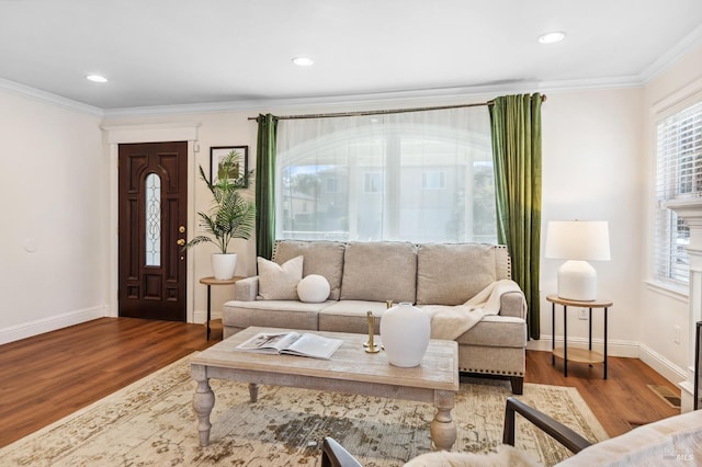 living room featuring ornamental molding, recessed lighting, baseboards, and wood finished floors