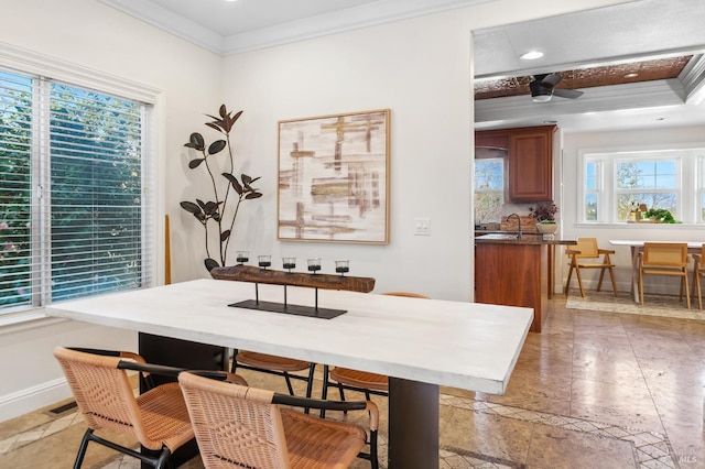 dining room with recessed lighting, crown molding, baseboards, and stone tile floors