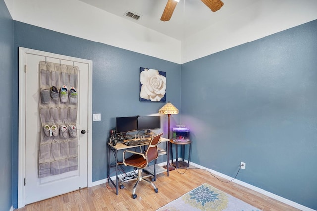 office area with ceiling fan, wood finished floors, visible vents, and baseboards