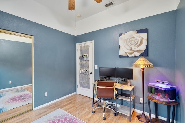 office area with baseboards, visible vents, ceiling fan, and wood finished floors