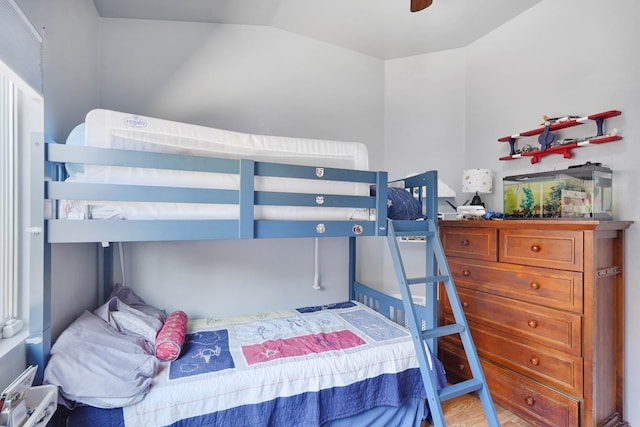 bedroom with lofted ceiling and wood finished floors